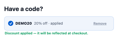 A Have a code? heading and, after the code was applied, the row DEMO20 20% off · applied with a Remove link, and the message Discount applied — it will be reflected at checkout